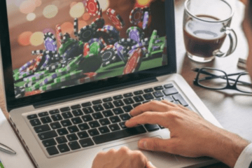 hand on laptop playing casino