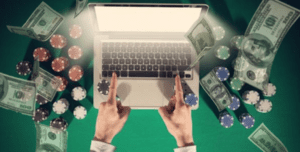 monye, laptop and poker chips